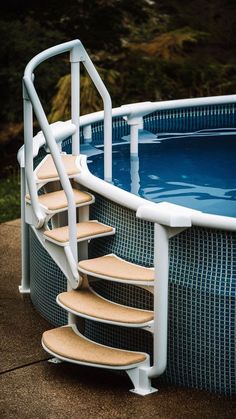 an above ground swimming pool with steps leading up to it