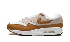 The Nike Air Max 1 SC "Bronze" is a colorway of the retro performance running shoe with an autumn-inspired look.  The “Bronze” rendition features a white mesh base with light grey suede overlays on the vamp, eyelets, mid-panel, and heel.  A Bronze leather Swoosh appears on each side of the shoe.  The autumn-esque hue is also found on the leather mudguard, as well as on the “Nike Air Max” branding on the tongue tag and “Nike Air” branding on the heel.  The shoe’s white foam midsole has a visible Bronze Shoes, Autumn Inspired, Nike Air Max 1, Stadium Goods, New Nike Air, July 7, Grey Suede, Cotton Bottoms, Vintage Pants