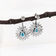 These beautiful earrings feature a pair of 13.98 carat weight pear shape Blue Zircon gemstones with natural earth mined diamonds set in solid 14K gold. These earrings make a lovely December birthstone gift for your loved ones! These earrings are made with solid 14k Gold and natural earth mined SI / G-H Diamonds. As listed, these earrings are ready to ship. If you're interested in purchasing this setting with a different center stone please message us! Pear-shaped Diamond Earrings With Gemstones, Pear-shaped Gemstone Diamond Earrings, White Gold Teardrop Gemstone Diamond Earrings, Fine Jewelry Pear-shaped With Halo Design, Fine Jewelry Pear-shaped Earrings With Halo Setting, Pear-shaped Diamond Earrings With Gemstone For Gift, Pear-shaped Diamond Earrings With Gemstones As A Gift, Fine Jewelry Diamond Teardrop Earrings For Gift, Fine Jewelry Diamond Teardrop Earrings As Gift