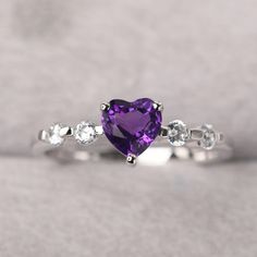 ◆ The ring is handcrafted from sterling silver and decorated with a dazzling 6*6 mm natural amethyst and tiny CZs. It is suitable for engagement/anniversary/daily occasion. ◆ Production Description: Main stone Type: Natural amethyst Main Stone Shape: Heart cut Main Stone Size: 6*6 mm(0.76ct) Side stone: CZ Metal: 925 Sterling silver - Other options available in the drop down menu ◆ Customization: √Free for Add Engraving √Other Metal Type Available √Other Gemstones & Shapes Available √Persona Silver Heart Rainbow Topaz Heart Rings Simple, Amethyst Rings With Brilliant Cut, Sterling Silver Birthstone Ring With Diamond White Gemstone, White Gold Brilliant Cut Amethyst Diamond Ring, White Gold Amethyst Diamond Ring With Brilliant Cut, White Gold Diamond Ring With Brilliant Cut Amethyst, Purple Brilliant Cut Ring, Elegant Purple Heart Ring For Anniversary, Fine Jewelry Purple Rings With Brilliant Cut