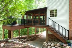 a house with a deck and stairs leading up to it