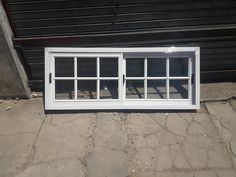 a white window sitting on the side of a building