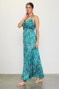 This pleated maxi dress features a vibrant print of tropical flowers. The strappy number has a tunnel tie that gathers the bust, so you can adjust the neckline as you like. •Adjustable spaghetti straps •Adjustable tie detail at bust •Pleated •Hidden back zipper Item Number: 99874 100% POLYESTER Green Ruched Spaghetti Strap Maxi Dress, Green Ruched Maxi Dress With Spaghetti Straps, Tropical Spaghetti Strap Dress With Tropical Print, Spring Tropical Maxi Dress With Spaghetti Straps, Tropical Spaghetti Strap Maxi Dress For Spring, Tropical Maxi Dress With Spaghetti Straps For Spring, Tropical Floral Print Maxi Dress With Spaghetti Straps, Green Ruched Maxi Dress For Vacation, Green Pleated Maxi Dress For Vacation