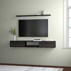 a flat screen tv mounted to the side of a wall