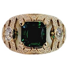 Hand Made Ring with Diamonds Ring Size 10.25 Material 14K Yellow Gold Center stone Emerald Emerald: CZ , dimension 9 x 9mm 2 stone: .35ct each, 70ct total Diamonds:2.5ct Total Carat: 3.20ct Diamond Clarity VS Color Grade G Weight: 12.4gr Gender: Unisex Condition : New, never worn Retail Price: $6.900 Ring Size 10, Diamonds Ring, Color Grading, Size 10 Rings, Diamond Clarity, Diamond Rings, Ring Designs, Band Rings, Gold Diamond