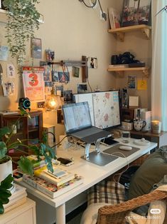 a home office with two computers on the desk