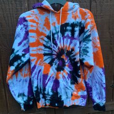 Halloween Tie Dye Sweatshirt // Orange, Purple, and Black Swirled Tie Dye Sweatshirt // Halloween Hoodie // Halloween Crewneck This is the perfect Halloween Tie Dye! The colors stay bright due to the content of the sweatshirt and will never fade. Perfect for trick or treating with the kids, a party or just your casual October Sweater. Will keep you cozy and warm this Fall. Sweatshirts are 90% cotton, 10% poly. Wash & Care: All items are pre-washed so they should not bleed or fade color. I recomm Casual Purple Hoodie For Halloween, Purple Long Sleeve Halloween Hoodie, Fun Hooded Fall Sweatshirt, Fun Hooded Top For Fall, Orange Drawstring Hood Top For Fall, Fun Fall Hoodie Sweatshirt, Hooded Tie-dye Tops For Fall, Fun Multicolor Sweatshirt For Fall, Hooded Tie Dye Top For Fall