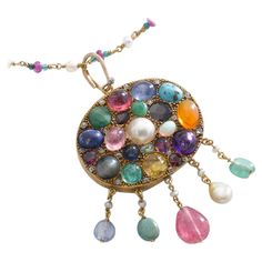 Multi Gems cabochon, Mother of Pearl and small diamond on Gold Pendant chain Necklace. Emerald, Sapphire, Ruby, Turquoise Matrix, Amethyst, Pearl, Opal, Citrine, Peridot, Garnet, Diamond. Mid 20th Century. Size of the pendant: Total height: 2.95 inches (7.50 centimeters) including bail. Total width: 1.77 inch (4.50 centimeters). Chain length: 24.80 inches (63.00 centimeters). Total weight pendant and chain: 38.64 grams. Former property of a French Lady. Elegant Multicolor Cabochon Gemstones, Fine Jewelry Multicolor Cabochon Gemstones, Multicolor Cabochon Gemstones Fine Jewelry, Multicolor Cabochon Gemstones For Fine Jewelry, Luxury Multi-stone Oval Cabochons, Yellow Gold Multi-stone Cabochons For Fine Jewelry, Yellow Gold Multi-stone Cabochons Fine Jewelry, Fine Jewelry Multi-stone Cabochons As Gift, Yellow Gold Jeweled Necklace