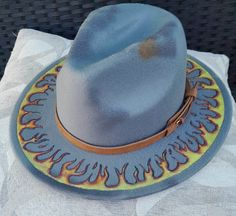 Hand burned , Hand Painted and distressed panama style hat. Adjustable fit. Casual Summer Felt Hat With Flat Crown, Summer Casual Felt Hat With Flat Crown, Casual Short Brim Felt Hat For Festivals, Distressed Curved Brim Hats For The Beach, Distressed Curved Brim Hat For Beach, Adjustable Faded Hat For Summer, Bohemian Distressed Summer Hats, Casual Fedora With Flat Crown For Country Events, Adjustable Faded Summer Hat