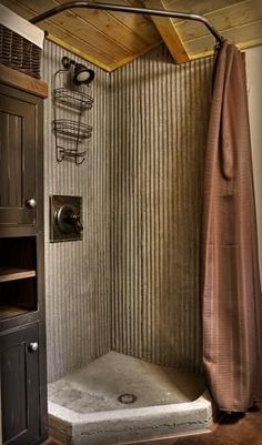 a bathroom with a shower stall and wooden ceiling