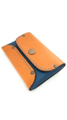 an orange and blue wallet with two holes