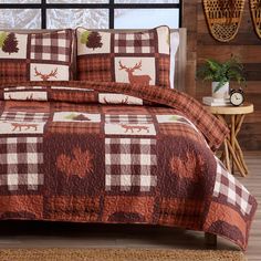 a bed covered in a brown and white checkered comforter next to a window