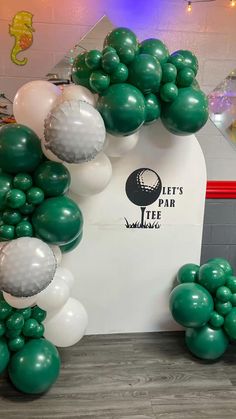 green and white balloons are on display in front of a sign that says let's park