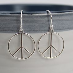 "Peace sign dangle earrings in solid 925 sterling silver. Light and comfortable, perfect for everyday wear. 1.25\" Long and .75\" Wide Solid 925 Sterling Silver Light weight and comfortable Artisan made in Texas Arrives thoughtfully packaged in a signature kraft jewelry box" 925 Peace Sign Earrings, Peace Sign Jewelry, Peace Sign Earrings, Peace Earrings, Girls Y2k, Festival Earrings, Hippie Earrings, Peace Signs, Opal Earrings Stud