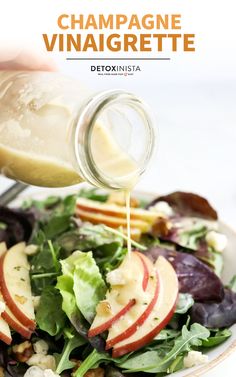 a person pouring dressing onto a salad with apples and walnuts on top, in front of the caption that reads champagne vinaignee detoxinsta