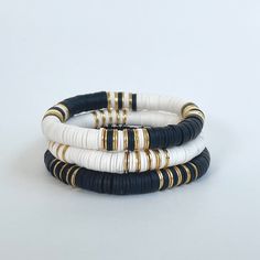 The Cruella bracelet stack will become your new daily go-to! The combination of black, white, and gold allows you to mix-and-match with so many other colors and styles.  I love to stack a few then add our Magnolia 14k gold bracelet.  Please note - each variation of the Cruella bracelet is available separately or snag them all as a set of 3!  Made with 8mm Heishi beads with gold brushed accent beads separating the color blocking 🌈Love neutrals, but looking for some color too?  🤍Our Fall/Jewel T Black White Jewelry, Clay Bead Bracelet Ideas Black And White, Heishi Bracelet Stack Ideas, Black And Gold Bracelet Stack, Black Heishi Bracelet Ideas, Neutral Bracelet Ideas, Clay Bead Bracelet Ideas Neutral Colors, Black And Gold Beaded Bracelets, Black And White Bracelets Beads