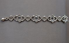 a silver bracelet with beads and stones on it