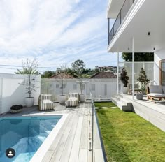 a backyard with a swimming pool and deck