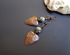 Hammered copper earrings. Hand-textured copper earrings. Raw African turquoise earrings. Rustic earrings. Bohemian earrings. Green stone earrings. Ethnic earrings. Copper patina earrings. OOAK. The copper parts of these earrings are hand cut from a bare copper sheet, hand-hammered, natural patinated and wax polished. The ear wires are handmade from pure copper wire. ● Materials: Natural stone, Copper ● Measures: - Length- about 2.44 inches (6.2 cm) x 0.87 inches (2.2 cm). ● Weight - 4 g each one Hammered Copper Earrings, Patina Earrings, Copper Jewelry Handmade, Rustic Earrings, Copper Sheets, Hammered Earrings, Copper Patina, Artisan Earrings, Ethnic Earrings