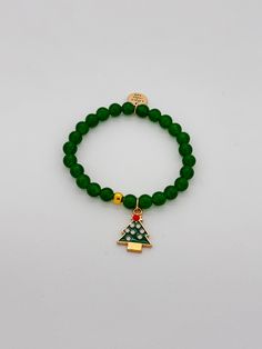 Green beads and gold accent beads with a Christmas Tree charm bracelet. Adorable by itself or stacked with a few other holiday bracelets! $18 By Little Miss Zoe Cheap Holiday Beaded Bracelets For Gift, Cheap Green Holiday Bracelets, Holiday Bracelets, Christmas Tree Charm, Holiday Beading, Bracelet Christmas, Christmas Tree Cake, Tree Cakes, Christmas Bead