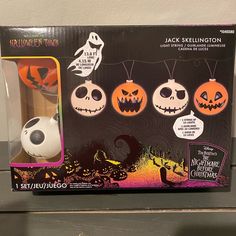 the jack skellingon toy is in its box and has three pumpkins on it