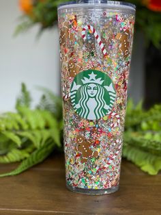 the starbucks cup is filled with colorful sprinkles