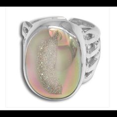 A 15x20mm Opalized Window Druzy Oval Is Bezel Set In 925 Sterling Silver In This Beautiful Ring! Opalized Druzy Shimmers And Shines With Many Colors Like Pink, Aqua And Yellow! This Stone Is 15x20mm And The Face Of The Ring Is Nearly 1". The Back Of The 1/4" Wide Band Has Been Left Open To Allow Gentle Re-Sizing Up To One Ring Size Larger. Width: 0.625 In Length: 1 In Height: 0.25 In Shimmer N Shine, Oval Rings, One Ring, Beautiful Ring, Wide Bands, Druzy Ring, Womens Jewelry Rings, Bezel Setting, Sterling Ring