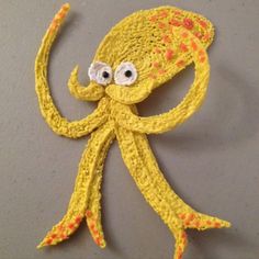 an octopus made out of yarn with googly eyes