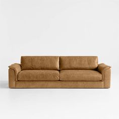 a brown leather couch against a white background