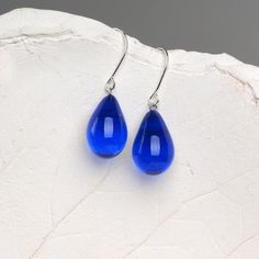 "These Small dark blue teardrop earrings are made of glass in lampwork technique. The earrings hooks are sterling silver and are hypoallergenic. These unique and beautiful earrings are like water drops frozen in glass! They are simple and elegant, very lightweight and comfortable to wear, perfect for everyday wear and for special occasions. 💕 You will definitely receive lots of compliments on your new earrings, everybody loves them, and you'll love them too! Dimensions: total length about 1 1/8 Black Statement Earrings, Small Drop Earrings, Blue Drop Earrings, Classy Earrings, Cobalt Blue Earrings, Glass Drop Earrings, Tear Drop Earrings, Lampwork Glass Beads, Black Earrings