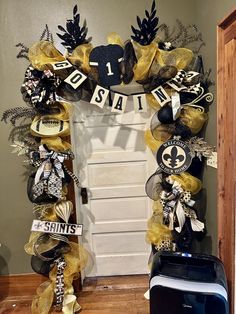 Attention New Orleans Saints fans ! Be the talk of your neighborhood with this beautiful, sparkling, black and gold Garling with stunning Saints decor, beautiful designer ribbon, and several large New Orleans Saints signs, Uniforms, footballs, and ornaments. You will sure be the talk of your neighborhood!  I have been in this business for over 26 years and I decorate everything from door wreaths, Christmas trees, door, swags, arrangements, mantels For each and every season of the year. Please co Saints Wreaths, Door Wreaths Christmas, Door Swags, Wreaths Christmas, Seasons Of The Year, New Orleans Saints, Gold Christmas, Door Decor, Door Hangers