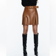 High Waisted Skirt With Self Belt Pleat Detail Back Hidden Inseam Zip Closure Whiskey Fall Season Belted Mini Skirt, Brown Belted Fitted Mini Skirt, Brown Leather Flared Skirt, Brown Fitted Belted Mini Skirt, Fitted Brown Belted Mini Skirt, Chic Leather Pleated Skirt For Fall, Brown Pleated Mini Skirt For Work, Fall Belted Mini Skirt, Belted Brown Skirt