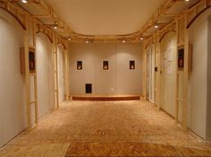 an empty room with several pictures on the wall and carpeted flooring in front of it