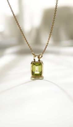 Indulge in the elegance and charm of our exquisite 14K Peridot Necklace, affectionately named "Moss." This stunning piece features a brilliant 2.9ct peridot gemstone set in 14k gold, making it a timeless addition to any jewelry collection. With an adjustable chain length of 45cm plus an additional 5cm, you can enjoy versatile styling options to match any outfit or occasion. Our "Moss" necklace weighs 4.43 grams, offering both a substantial yet comfortable feel. Handcrafted with meticulous attention to detail, this beautiful necklace shines with natural peridot's fresh, green hue, evoking the tranquil beauty of nature. The radiant 14k gold complements the peridot flawlessly, making it a perfect accessory for elevating everyday wear or adding a touch of sophistication to formal attire. To en Luxury Peridot Necklace, Luxury Yellow Gold Peridot Jewelry, Elegant May Birthstone Necklace With Rectangular Pendant, Fine Jewelry 14k Gold Rectangular Pendant Necklace, Classic Green Necklace With Rectangular Pendant, White Gold Necklace With Gemstone Rectangular Pendant, 14k Gold Rectangular Pendant Necklace, Luxury Yellow Gold Birthstone Necklace For Gift, Luxury Gold Peridot Jewelry