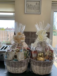 two wicker baskets with coffee mugs and candies