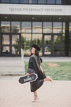 a woman in graduation gown holding a sign that says, don't do it