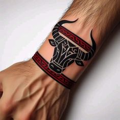 a man's arm with a tattoo on it and a bull head in the middle