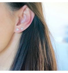 a close up of a person wearing some kind of ear piercing