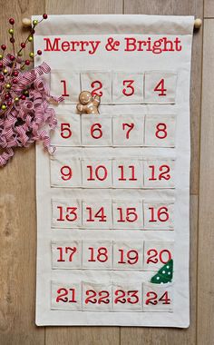 a white christmas calendar hanging on a wall