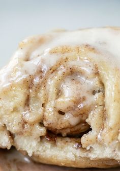 a cinnamon roll with icing on top of it