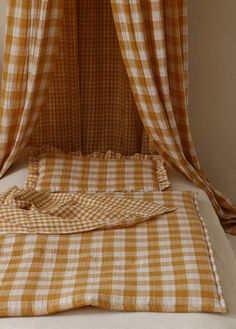 an orange and white checkered bed spread