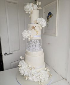 a three tiered wedding cake with white flowers