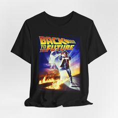 BACK to the FUTURE Tshirt T-shirt T shirt Vintage Aesthetic Movie Tee 1980s Style Shirt This classic unisex jersey short sleeve tee fits like a well-loved favorite. Soft cotton and quality print make users fall in love with it over and over again. These t-shirts have-ribbed knit collars to bolster shaping. The shoulders are tapered for a better fit over time. Dual side seams hold the garment's shape for longer.  .: 100% Airlume combed and ringspun cotton (fiber content may vary for different colors) .: Light fabric (4.2 oz/yd² (142 g/m .: Retail fit .: Tear away label .: Runs true to size 90s Inspired Graphic Print T-shirt For Fans, 90s Inspired Short Sleeve T-shirt For Fans, 90s Inspired T-shirt With Graphic Print For Fans, 90s Inspired Short Sleeve T-shirt With Graphic Design, 90s Inspired Short Sleeve Graphic T-shirt, 90s Inspired Short Sleeve T-shirt With Sublimation Print, Film Tshirt, Aesthetic Movie, 1980s Style