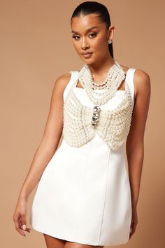 Available In Off White. Duchess Satin Mini Dress Sleeveless Square Neckline Constructed Skirt Hidden Back Zipper Lined Non Stretch Removable Pearl Embellished Top Back Closure Shell: 95% Polyester 5% Spandex Lining: 95% Polyester 5% Spandex Pearl Top: 100% Fake Pearls Imported | Zahra Embellished Mini Dress Set in Off White size Medium by Fashion Nova Chic Sleeveless Dresses With Pearl Embroidery, Elegant Fitted Halter Neck Vest, Elegant White Party Vest, Fitted Embellished Vest, Chic Sleeveless Beaded Dresses, Elegant Embellished Summer Vest, Embellished Sleeveless Evening Vest, Elegant Sequined Vest For Spring, Evening Embellished Sleeveless Vest