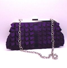 "This classic purple satin purse is from Jessica McClintock, circa 1990's. This item is in good vintage condition with minor signs of wear. It features pleated detailed satin, a silver chain shoulder strap, which tucks in if you want a clutch bag, a snap close and an inside side pocket.  It measures approximately 9-3/4\" wide x 5\" tall x and the silver shoulder chain measures 12\" in length. Jessica, who passed away in 2021 often spoke of her belief that \"Romance is beauty that touches the emo Elegant Purple Evening Bag For Formal Occasions, Purple Rectangular Clutch For Formal Occasions, Elegant Purple Shoulder Bag For Party, Formal Purple Rectangular Clutch, Purple Clutch Evening Bag For Formal Occasions, Purple Clutch Evening Bag For Events, Purple Chain Strap Shoulder Bag For Formal Occasions, Formal Purple Shoulder Bag With Chain Strap, Formal Purple Clutch Evening Bag