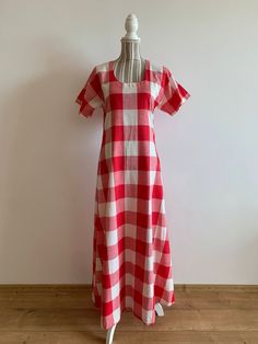 "This is a beautiful vintage cotton red and white white checkered dress with short sleeves and scoop neck. This cottage core maxi dress is made of lovely check print cotton fabric which is perfect for the summer season. As it was handmade, there is no label to show the materials or size. The fabric feels like cotton or could be linen/cotton blent. It has no stretch. This romantic bohemian style dress has a simple a line silhouette. There is no size marked on this bohemian dress, it fits like size S M. Please check the measurements below.  The belt does not come with the dress. It can be purchased separately here - https://www.etsy.com/listing/1548547229/vintage-80s-red-leather-waist-belt-rope?click_key=f206803bf793a66e012d62fae8636080087152f1%3A1548547229&click_sum=30732eeb&ref=shop_home_a Square Neck Cotton Plaid Dress, Vintage Gingham Plaid Dress For Summer, Vintage Gingham Dress With Short Sleeves, Red Cotton Plaid Dress For Picnic, Vintage Summer Plaid Dress For Picnic, Vintage Short Sleeve Plaid Cotton Dress, Vintage Style Gingham Plaid Short Sleeve Dress, Vintage Gingham Plaid Dress With Short Sleeves, Vintage Short Sleeve Plaid Dress For Spring