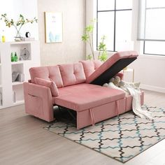 a living room with a pink sectional sofa and storage underneath the chaise longue