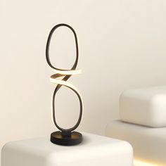 a modern sculpture sitting on top of a white table