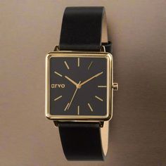 Introducing new Arvo Time Squared Watches for women! This version features a black dial and a 32mm square polished gold case that creates a classy style. The black leather band and gold buckle finish the look. This minimalist design is perfect for dress or casual wear. Add Arvo Time Squared Watches for women to your Arvo collection and get ready for compliments! PLAY the product video to see more detail! The Quick Release function of Arvo watch bands make them easy to switch out in a minute or t Chic Gold Watch With Rectangular Dial, Black Watches With Rectangular Dial For Evening, Chic Gold Watches For Work, Black Rectangular Dial Watch For Work, Elegant Black Square Watch, Gold Office Watch With Leather Strap, Gold Leather Strap Watch For Office, Gold Watches With Leather Strap For Office, Black Square Watch For Formal Occasions