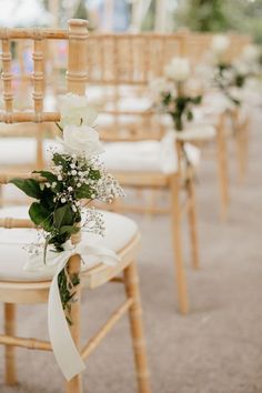 the chairs are decorated with flowers and ribbons